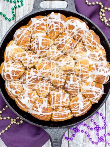 Your taste buds will be tantalized with these Skillet Cinnamon Rolls.  They are easy to make by starting with frozen rolls, the right amount of cinnamon and sugar and drizzled with a vanilla glaze.  Your kitchen will smell amazing too while they are baking!